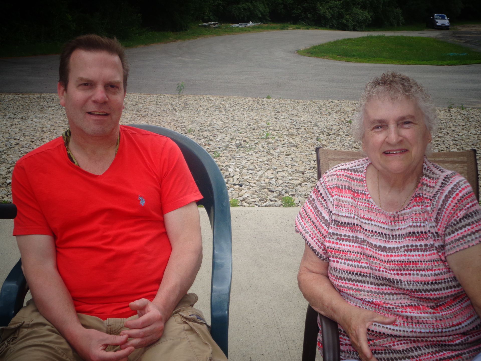 A man and a woman are sitting next to each other in chairs.
