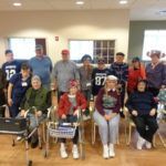 A group of people are sitting in chairs in a room.
