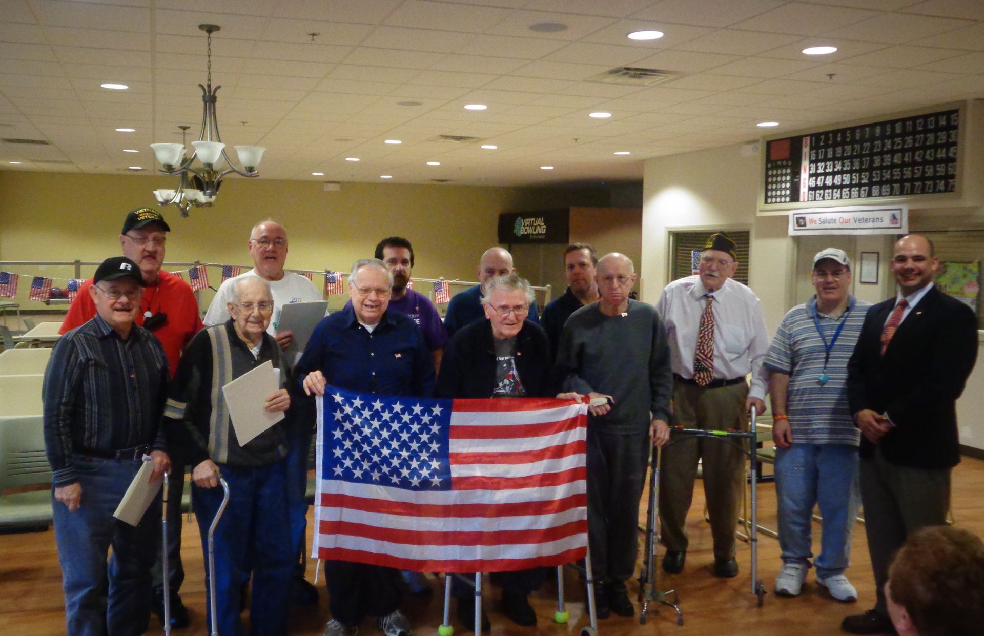 A group of older men holding an american flag