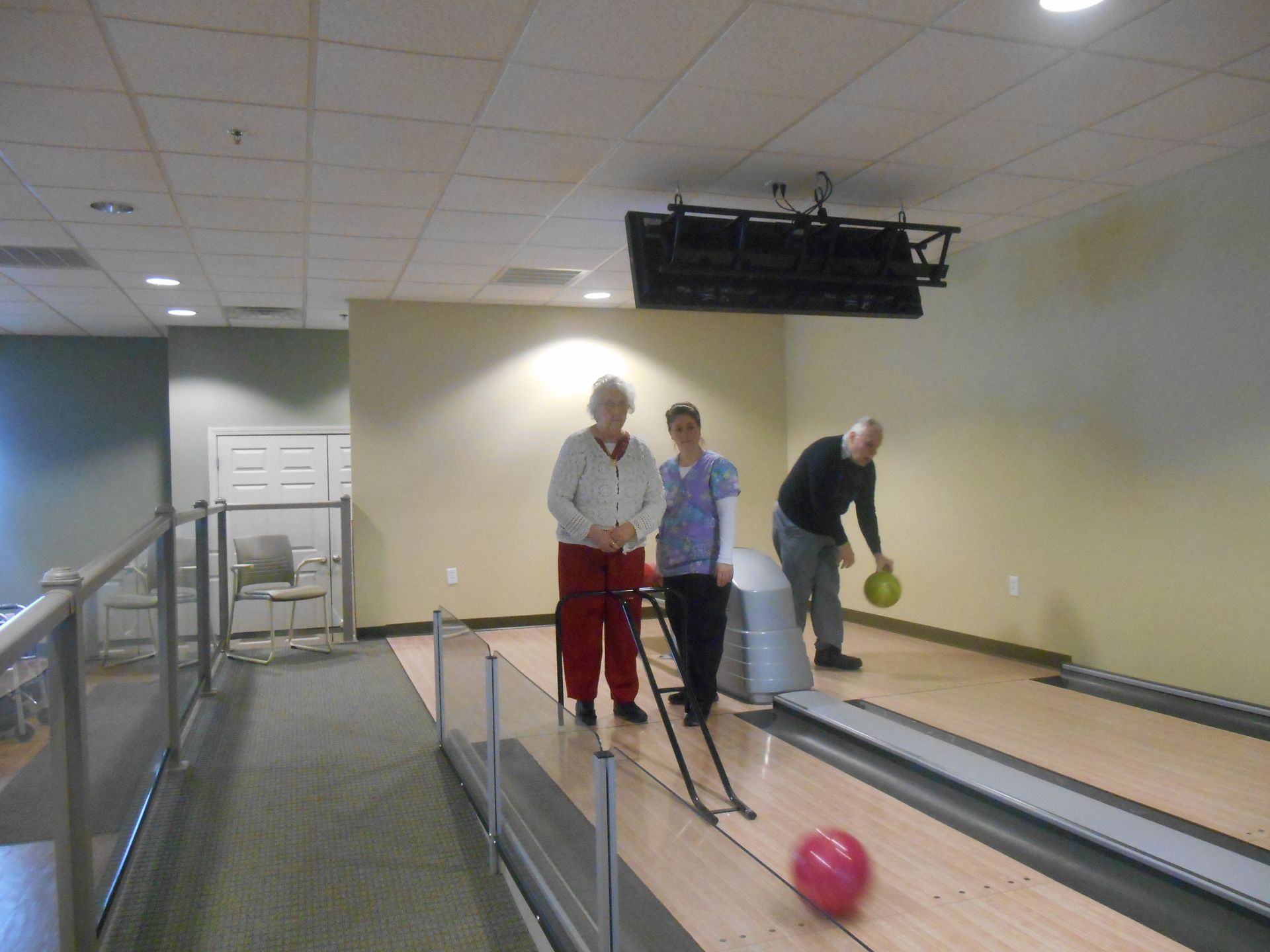 A group of people are bowling on a bowling alley