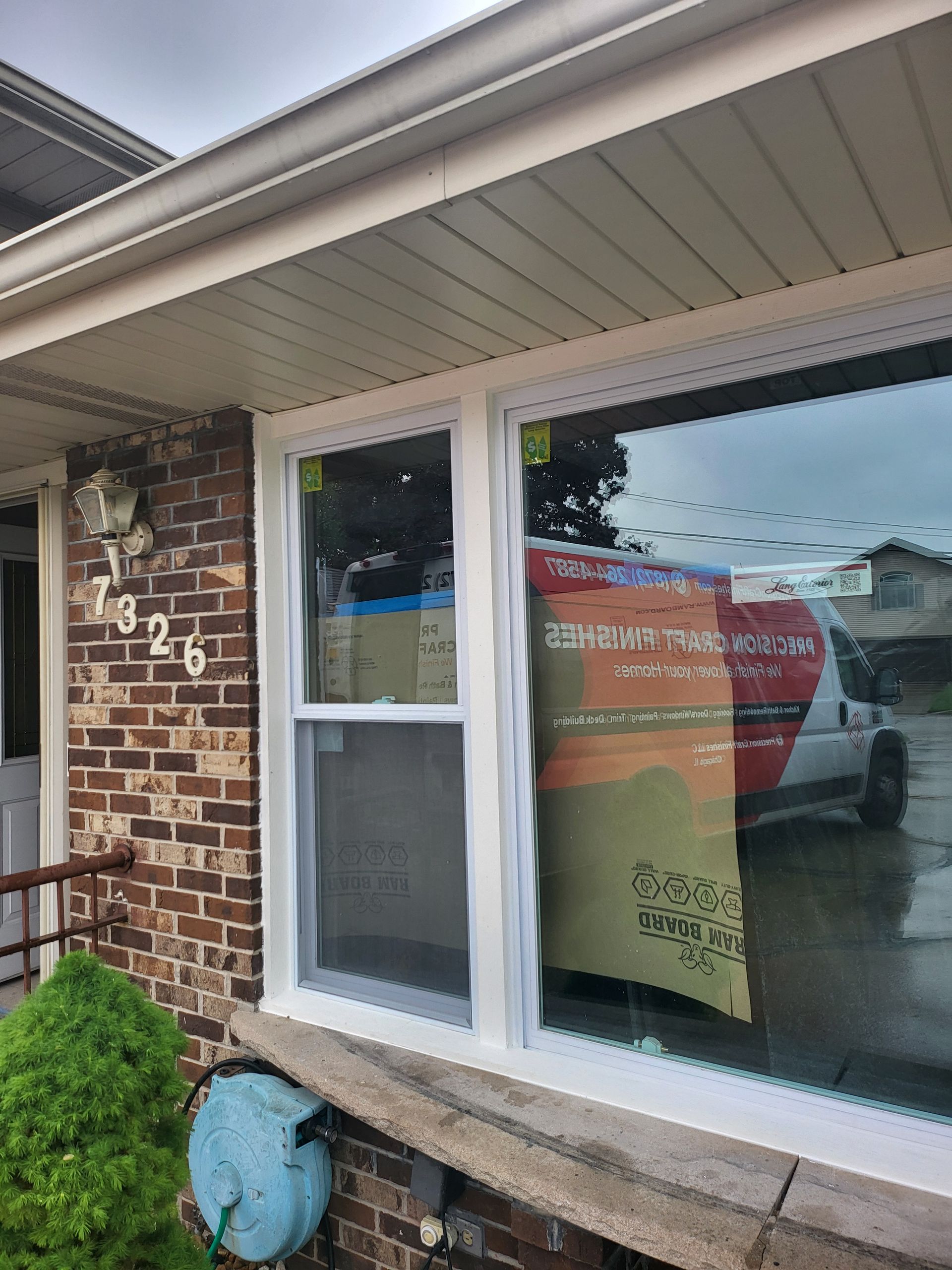 Construction scene: a laser level projects a red line along a wall, scaffolding, and masking tape on the floor.