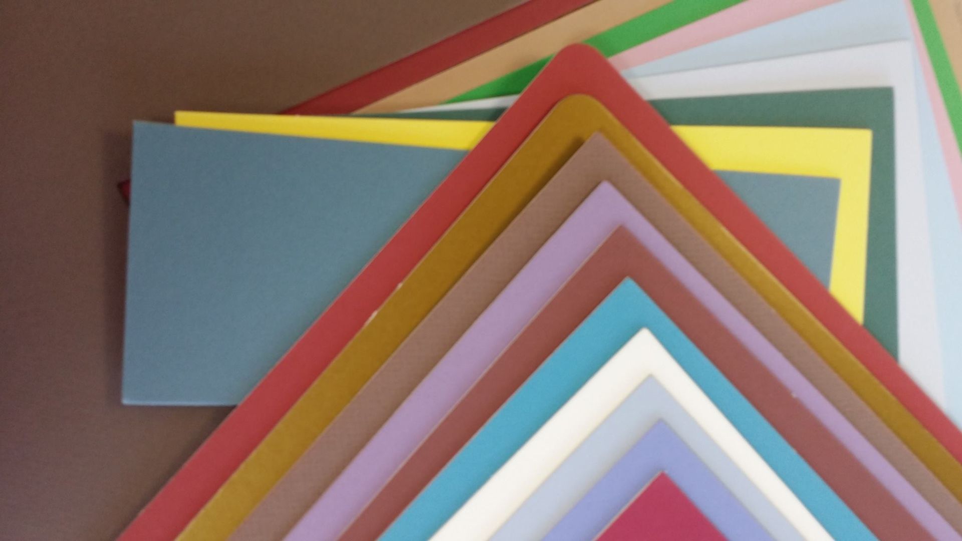 A bunch of different colored paper stacked on top of each other