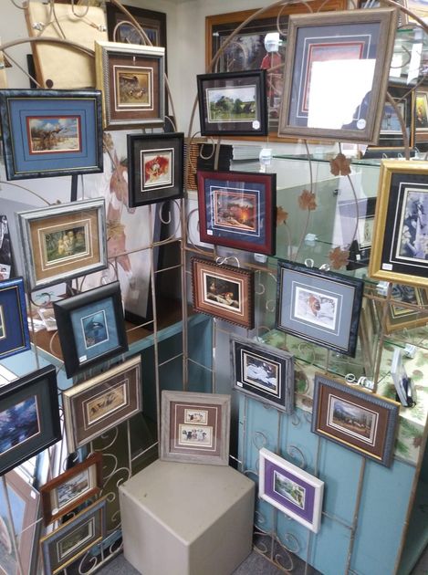 A room filled with lots of framed pictures on display