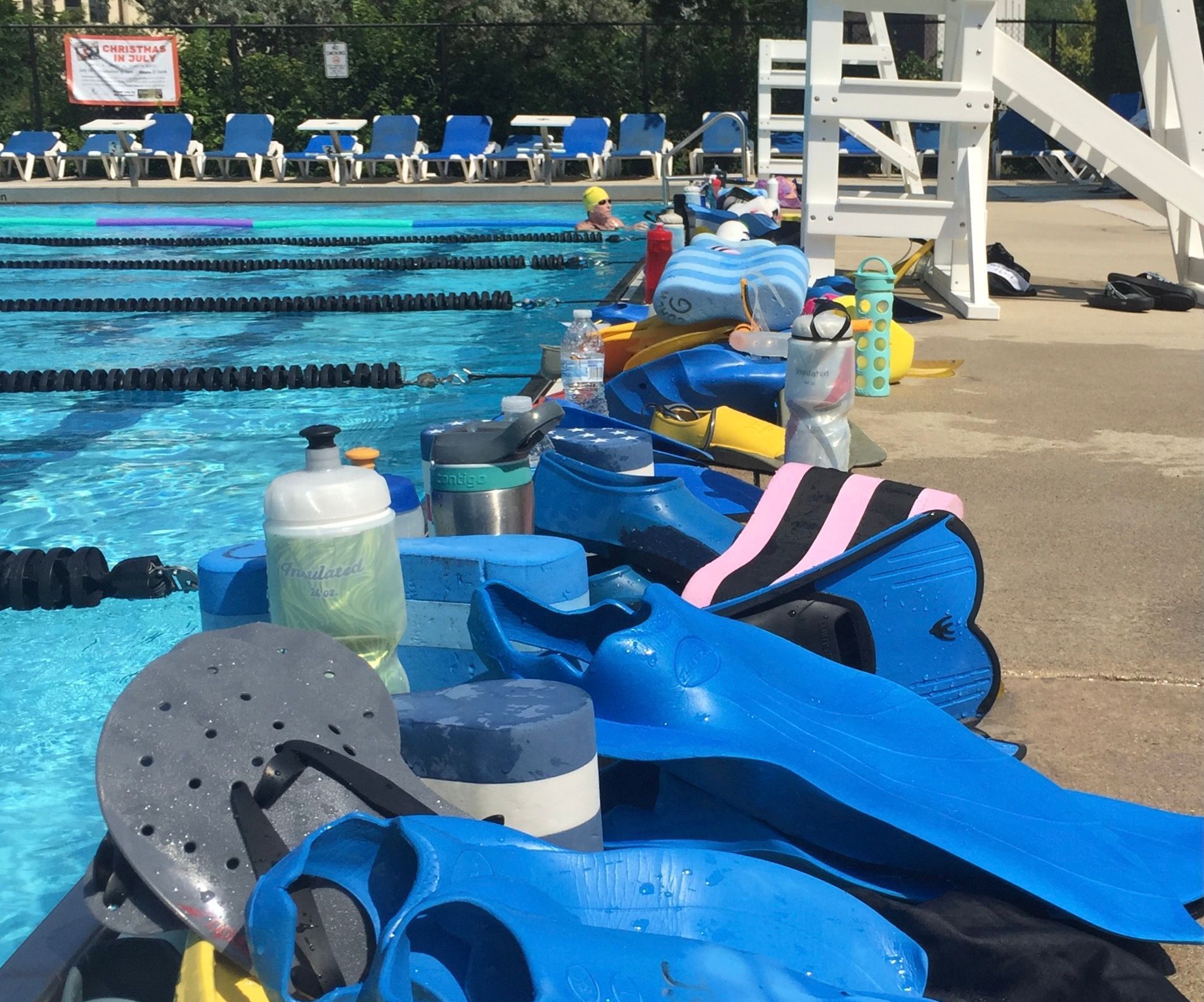 A swimming pool with a lifeguard chair in the background