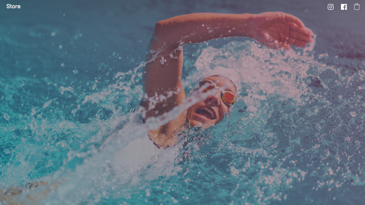 A man is swimming in a swimming pool.