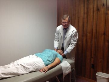 Doctor adjusting neck —Shoulder Pain in Saraland, AL