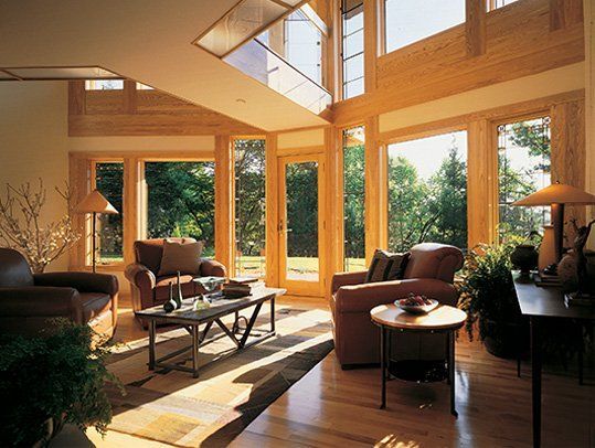 A living room with a lot of windows and furniture