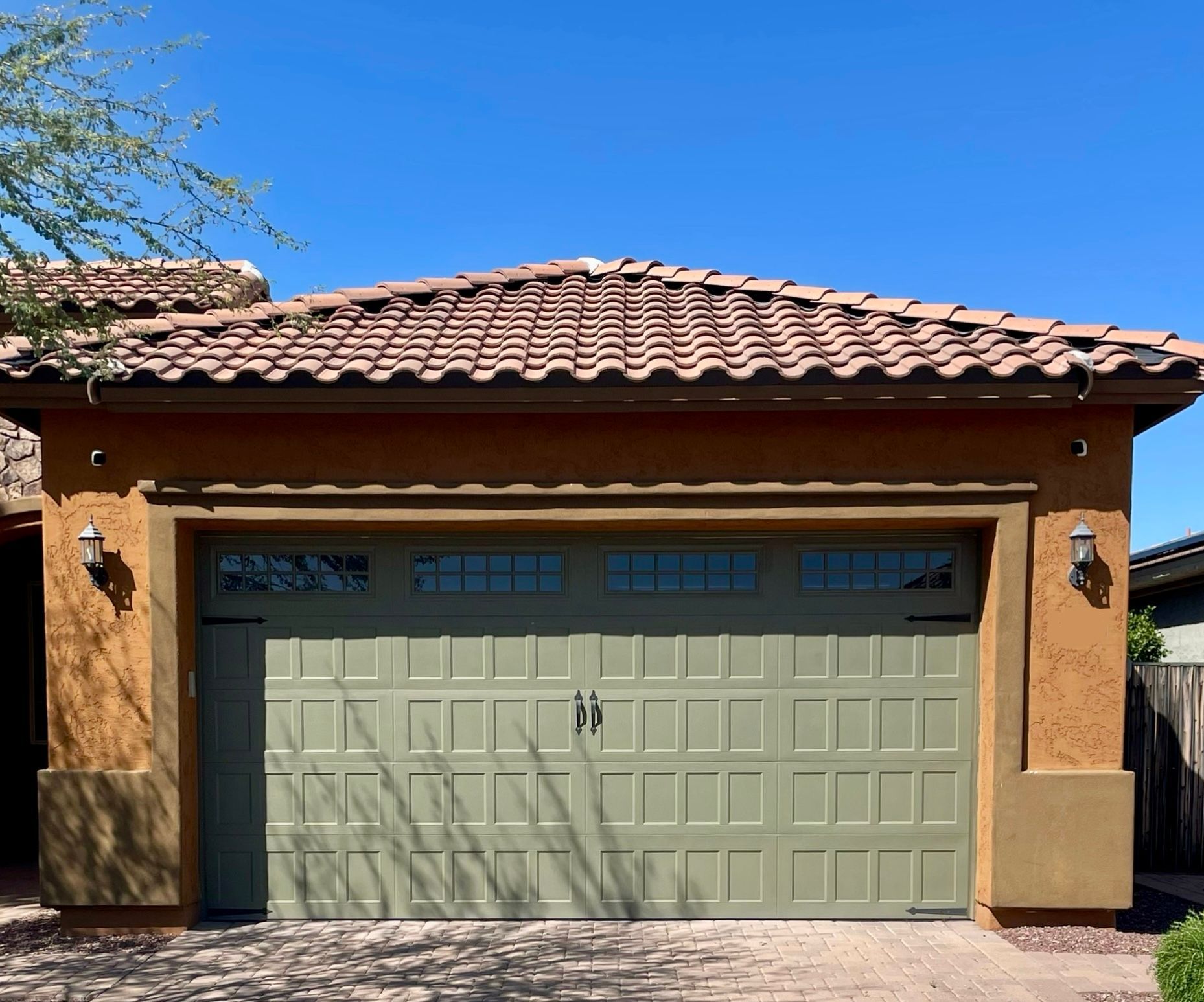 A house with a green garage door and a tile roof