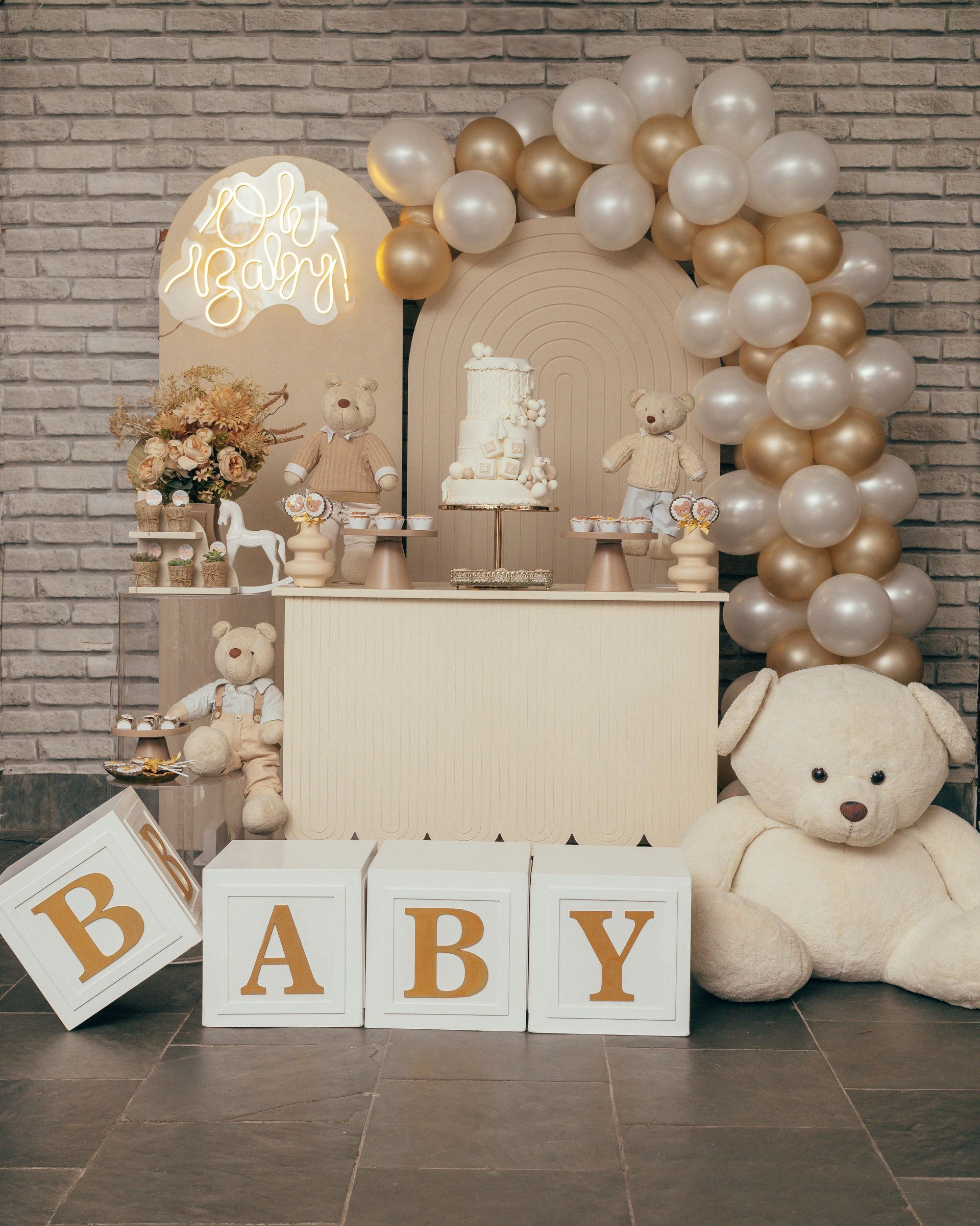 A baby shower with a teddy bear and balloons