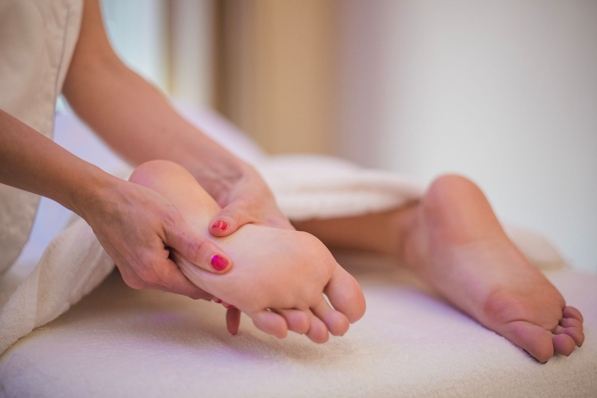 A woman is getting a foot massage at a spa.