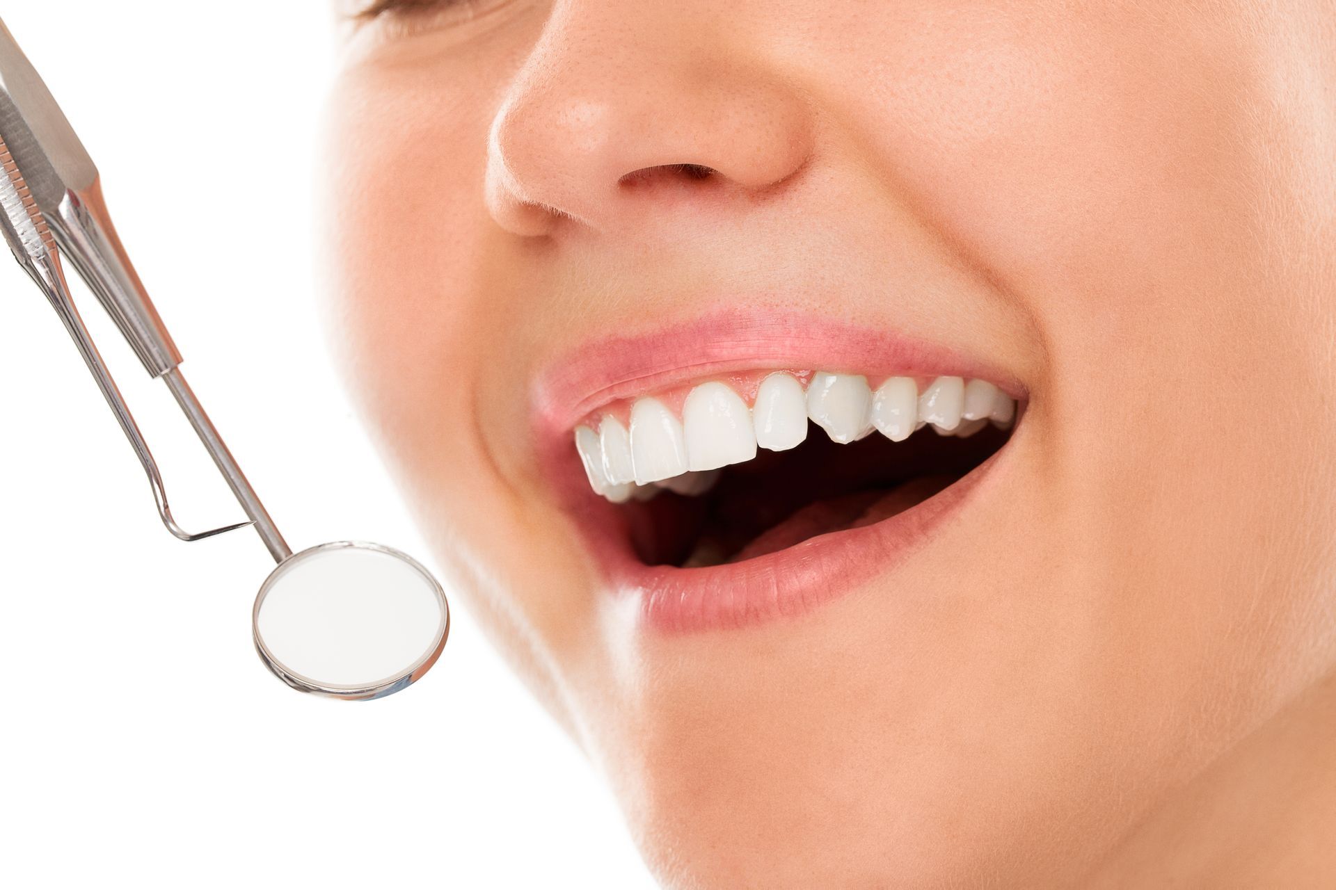 A woman is getting her teeth examined by a dentist.