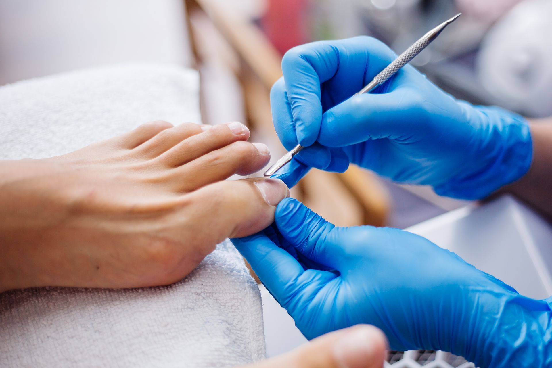 A person is getting their toenails done at a nail salon.