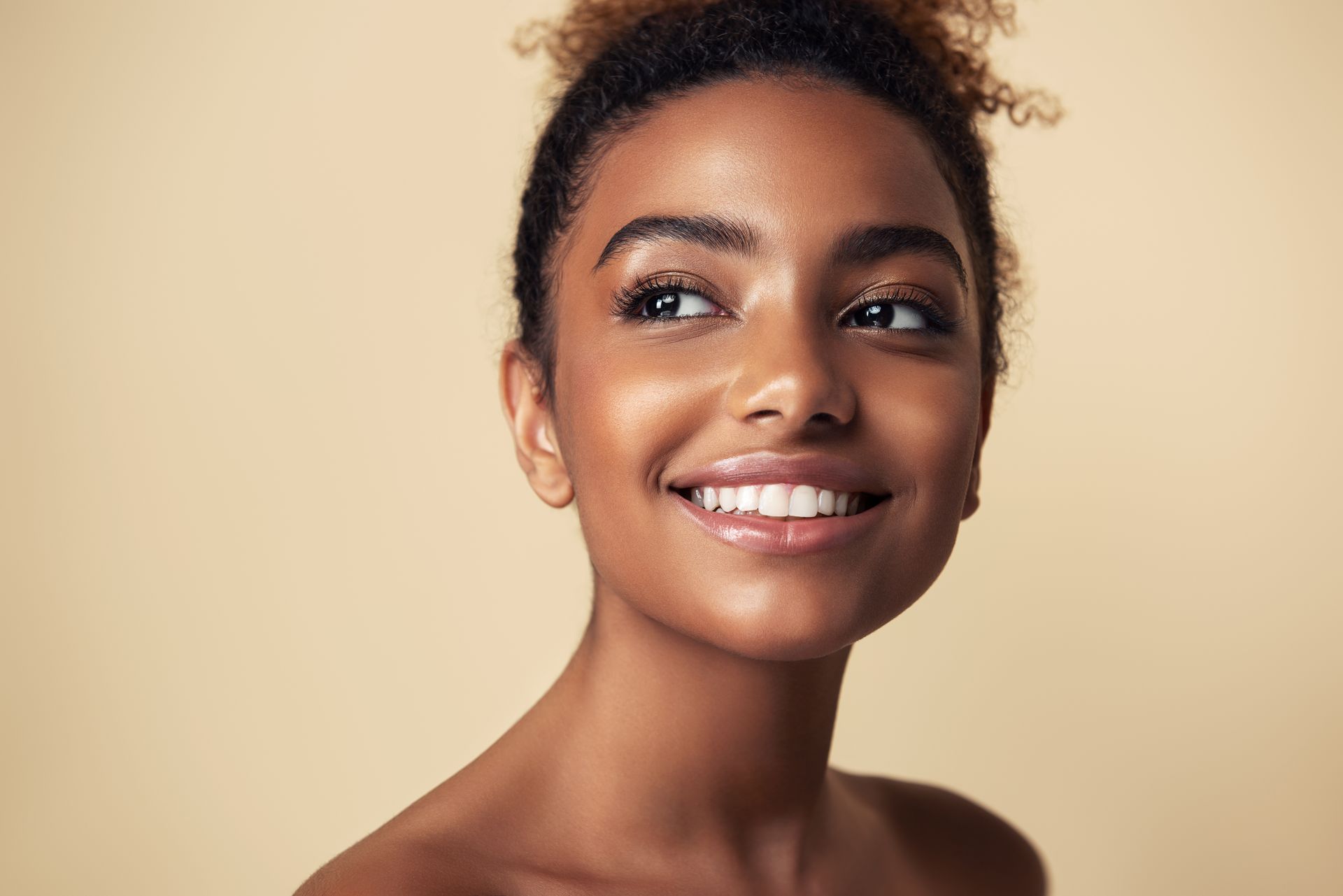 A close up of a woman 's face with a smile on her face.