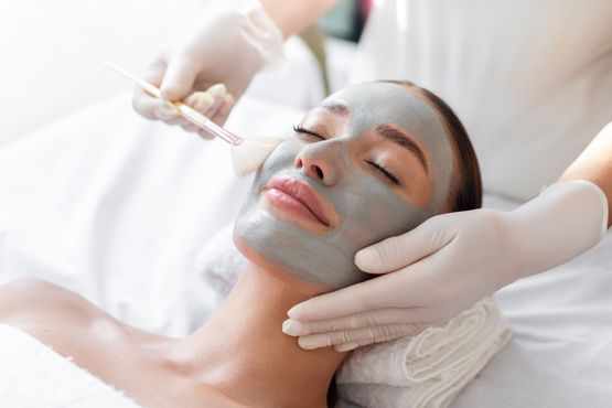 A woman is getting a facial treatment at a spa.