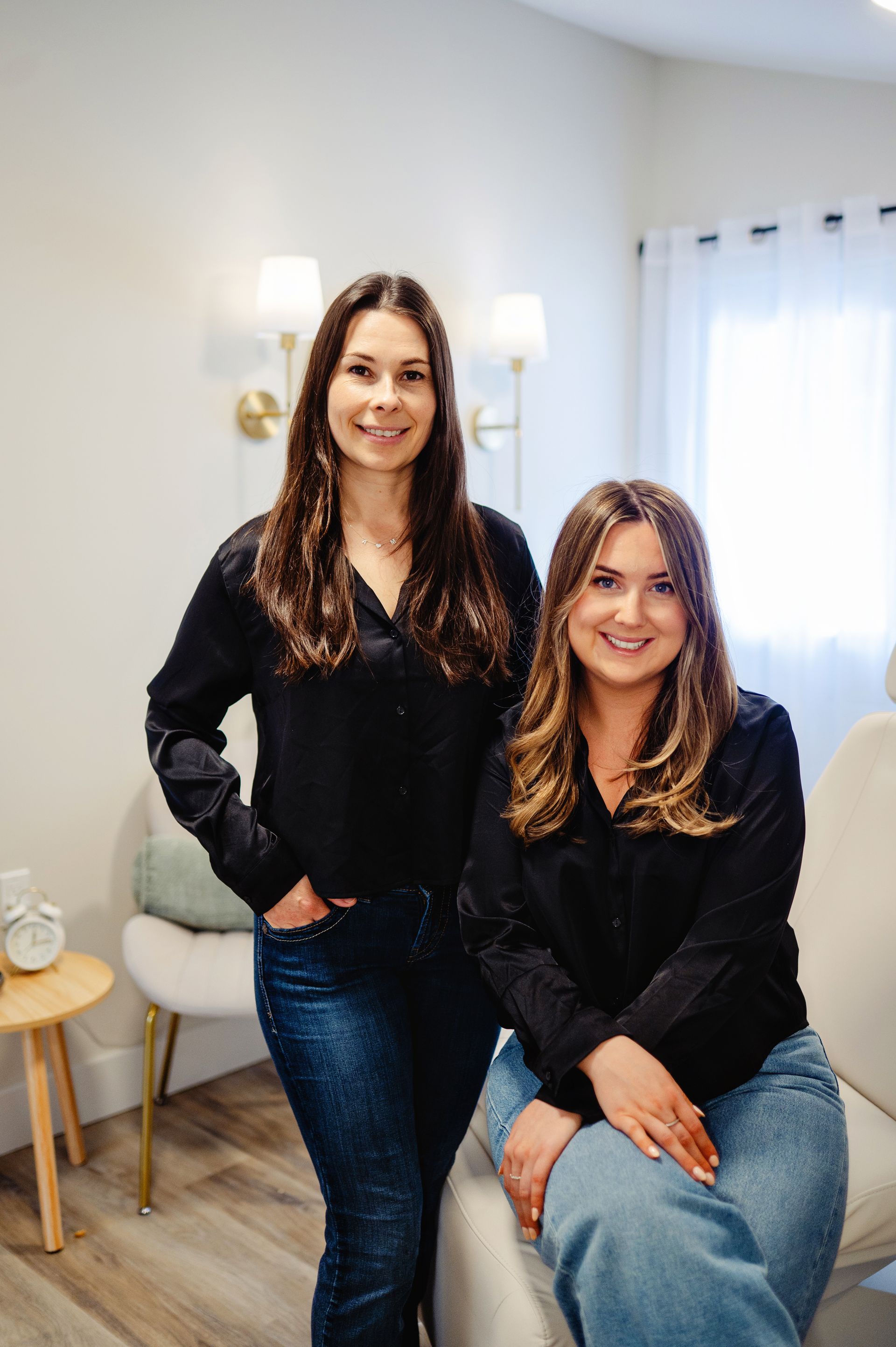 Three women in black scrubs are posing for a picture together.