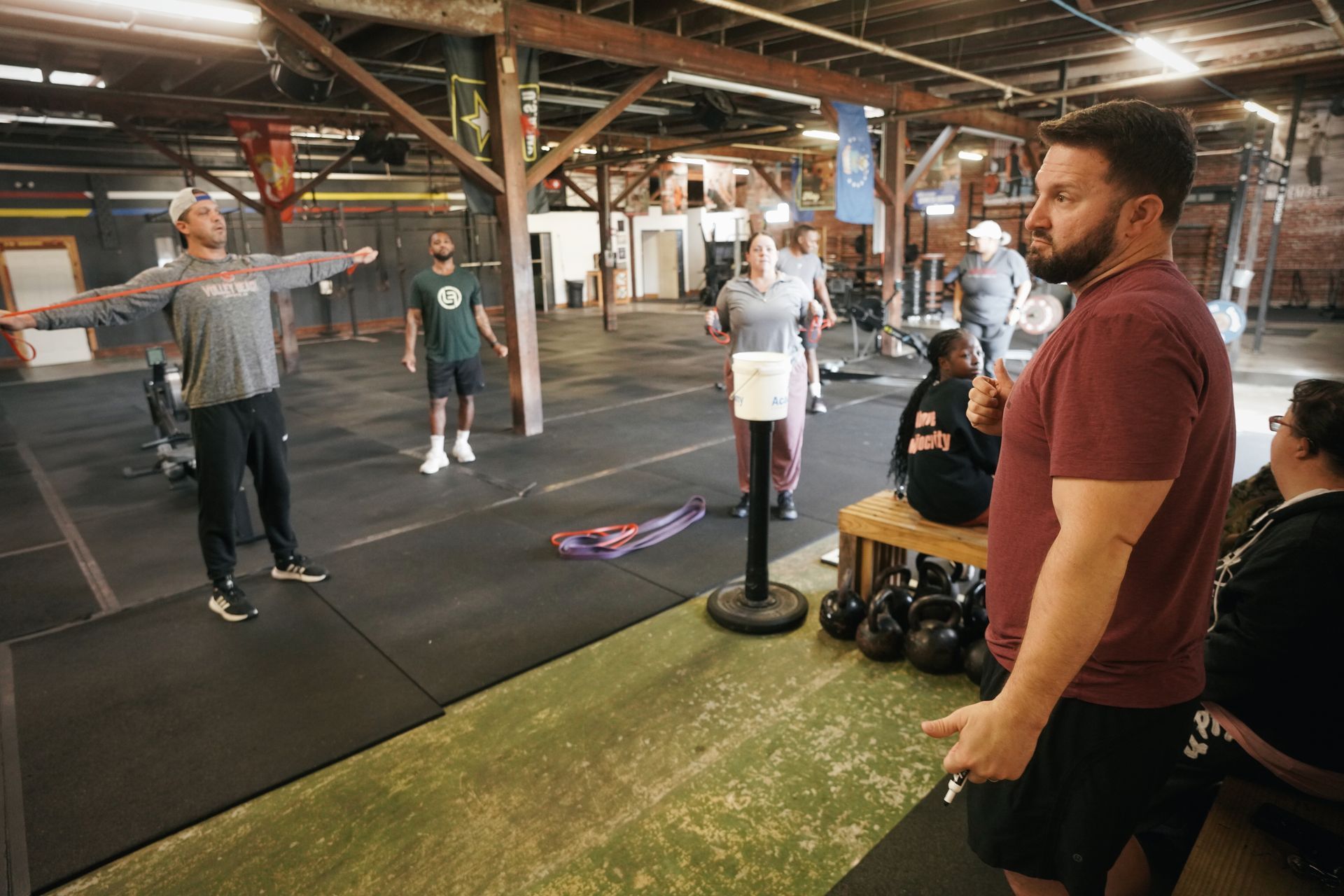 Coach leading a strength training class at Grounded Fitness Acadiana in Lafayette.