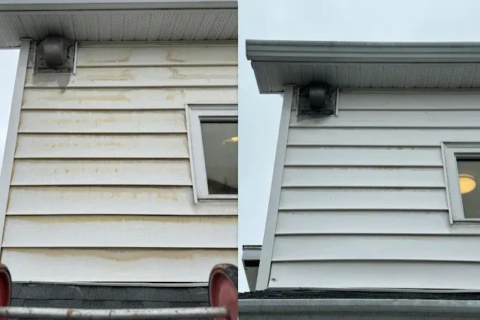 Comparison of a dirty and clean white vinyl siding of a house; the before side is stained.