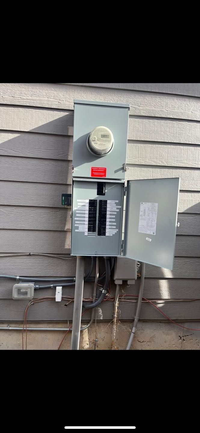 Exterior electrical panel with the door open, showing circuit breakers and wiring. Mounted on siding.