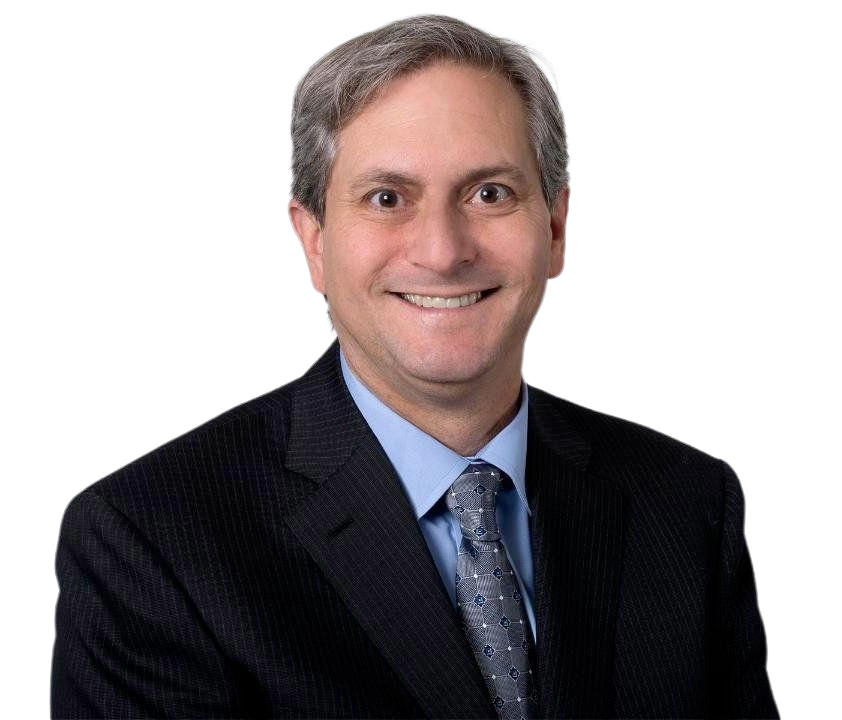 Man in suit smiling, looking at the viewer. Blue shirt, patterned tie. White background.