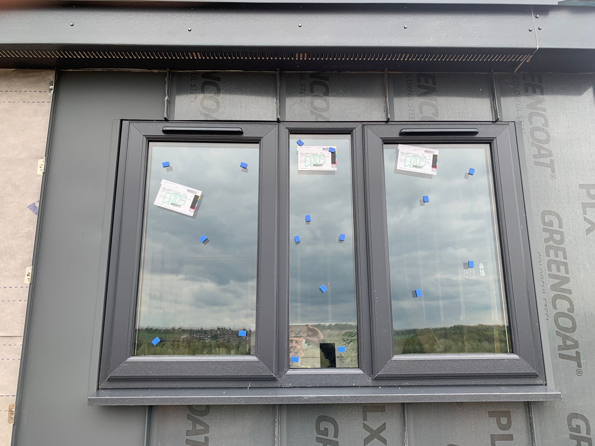 A window is being installed on the side of a building.