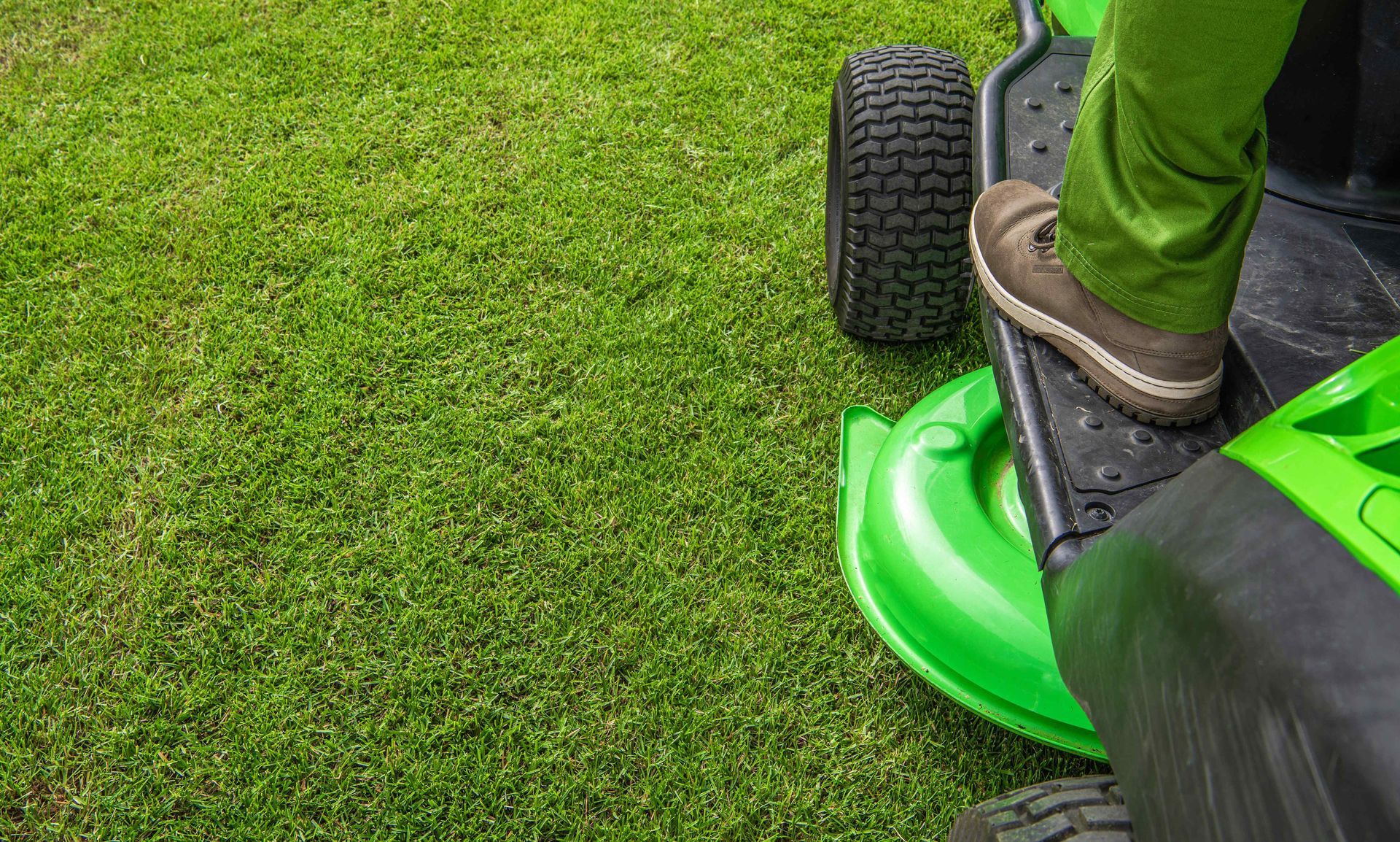 Mowing grass on ride on lawn mower