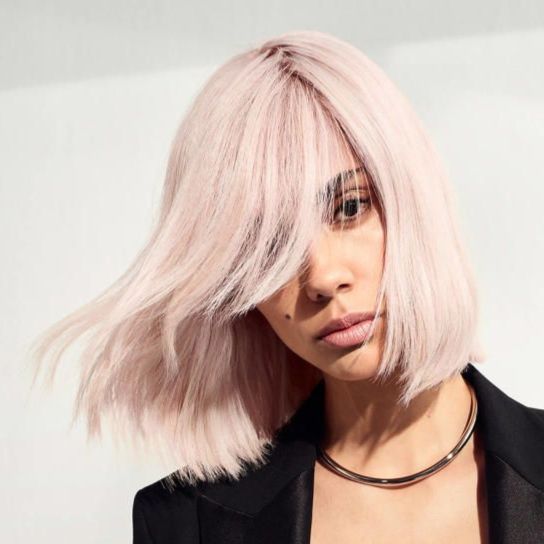 a close up of a woman 's face with curly hair .