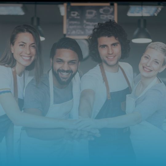 A group of people are shaking hands in a restaurant.
