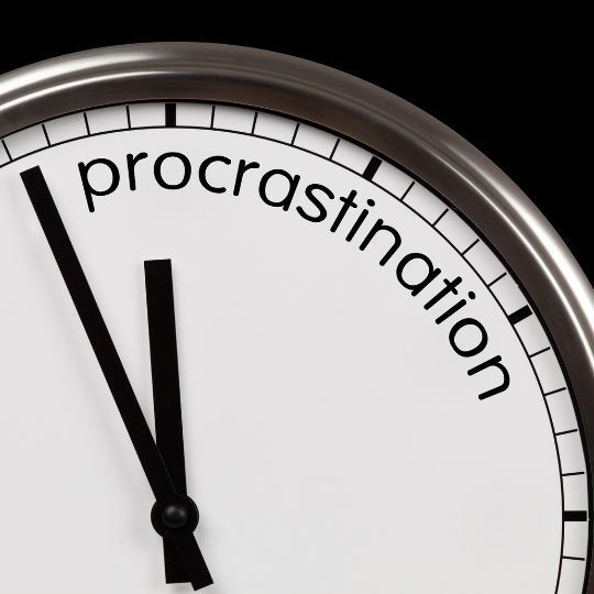 A clock with the word procrastination on it