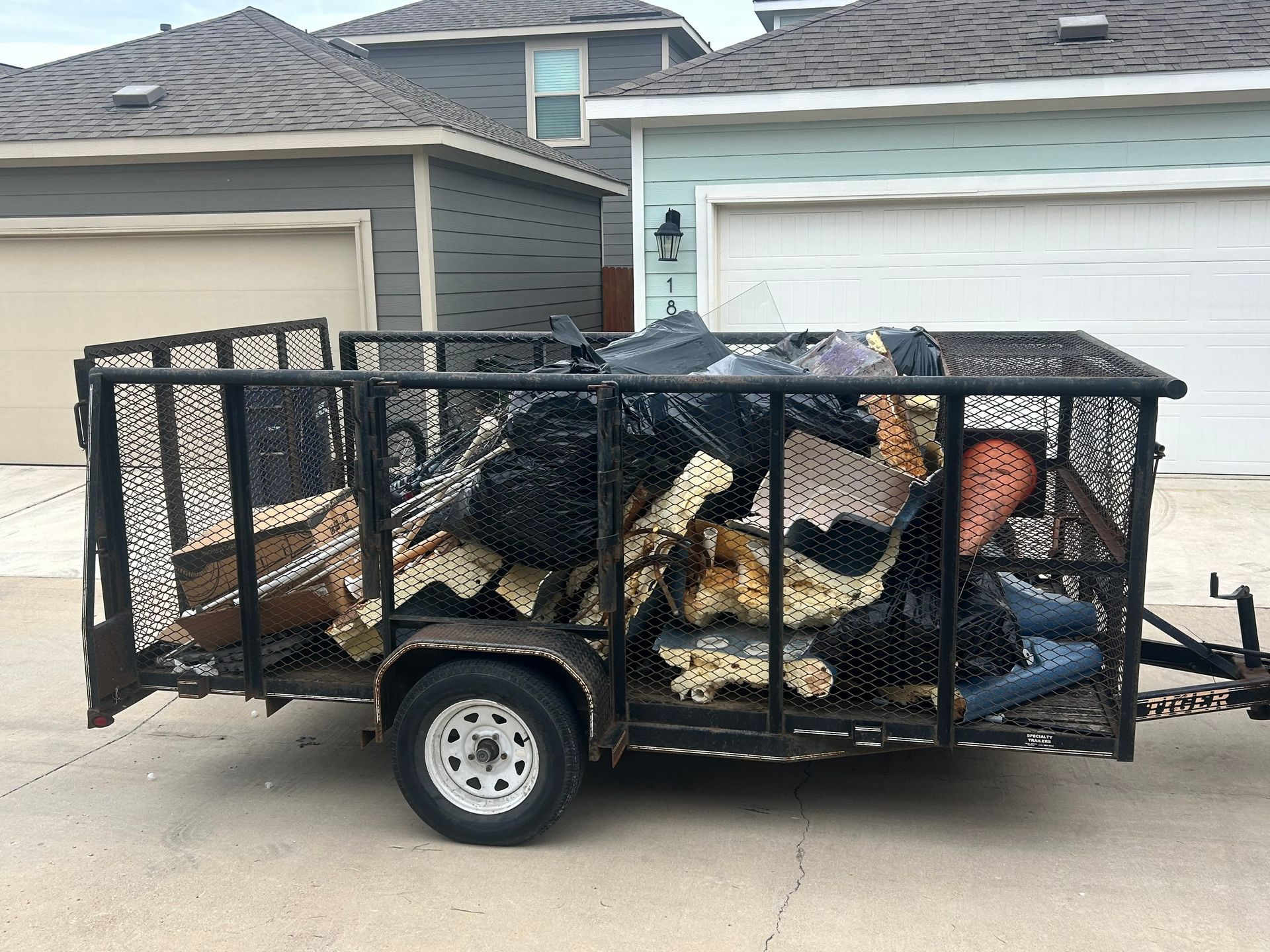 Jacked Hauling truck removing debris and junk