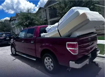 Jacked Hauling truck loaded with mattresses 