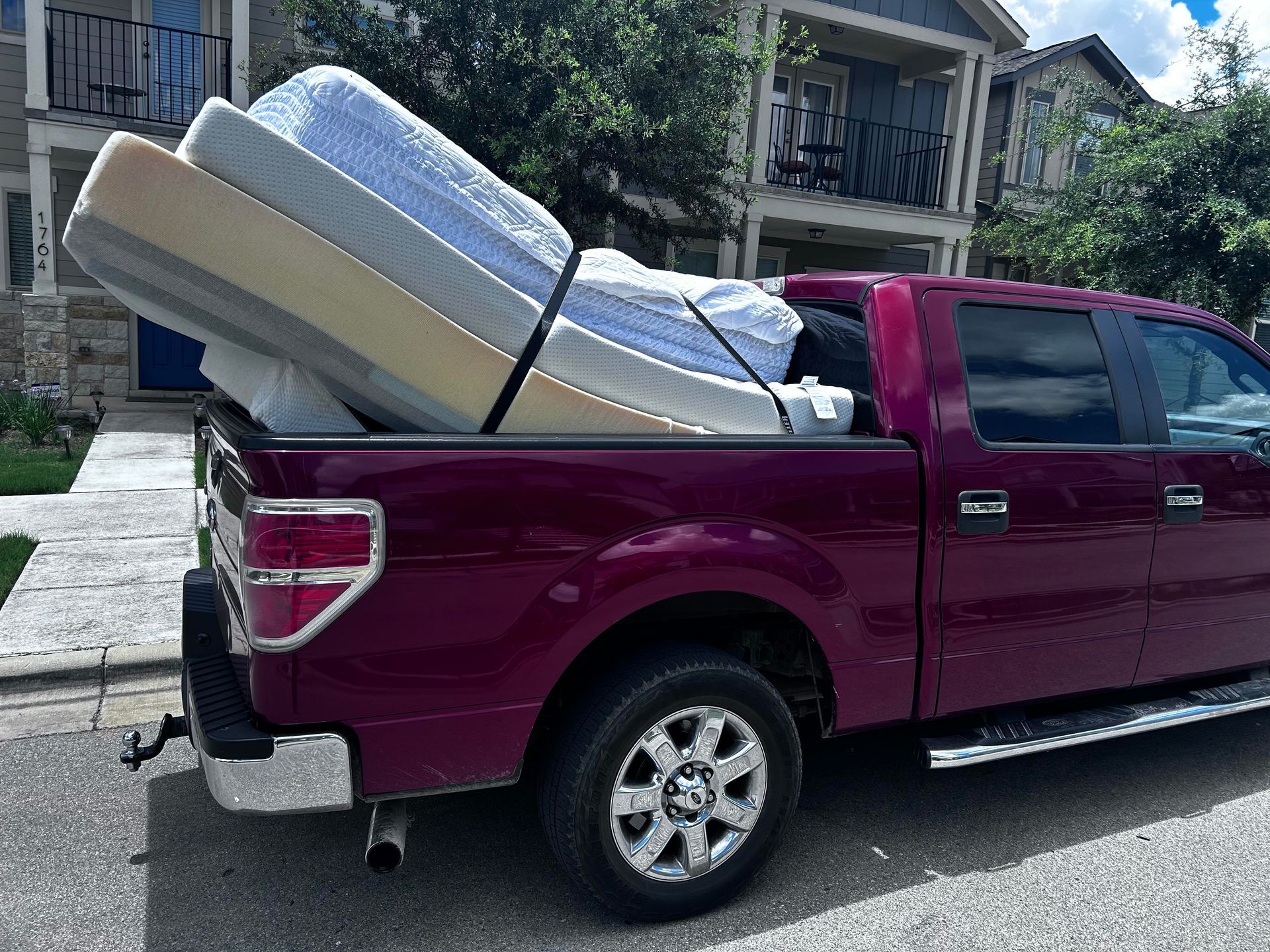 Jacked Hauling truck loaded with old mattresses 