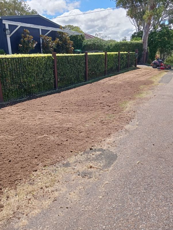 A Dirt Road With A Fence And A House In The Background — Amaze Lawn and Garden Care In Anna Bay, NSW