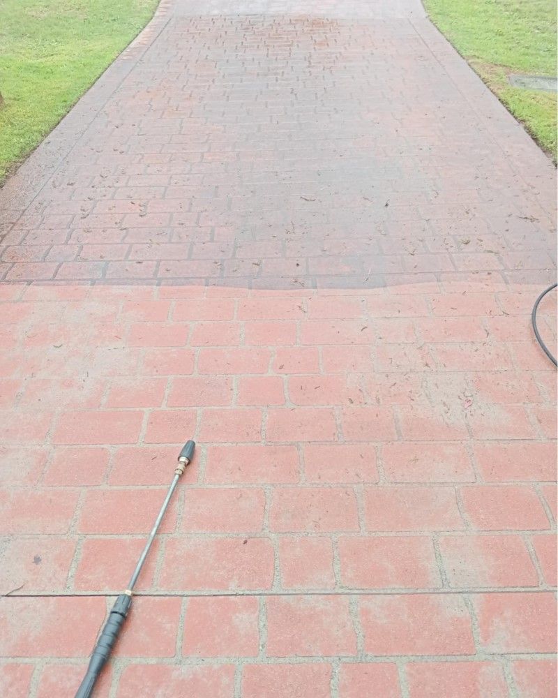 A Pressure Washer Is Being Used To Clean A Brick Driveway — Amaze Lawn and Garden Care In Nelson Bay, NSW