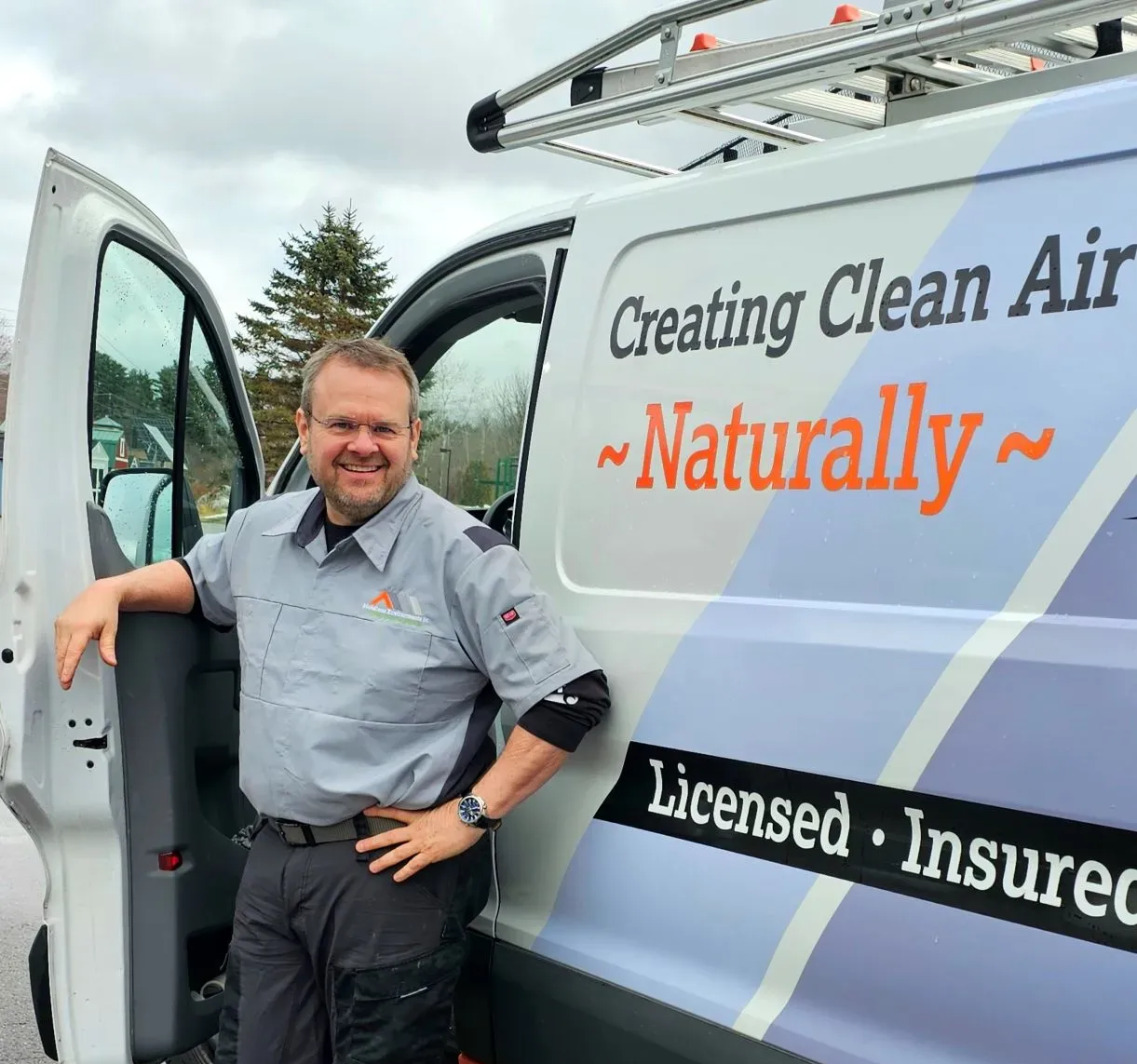 Man in uniform stands by a van with 