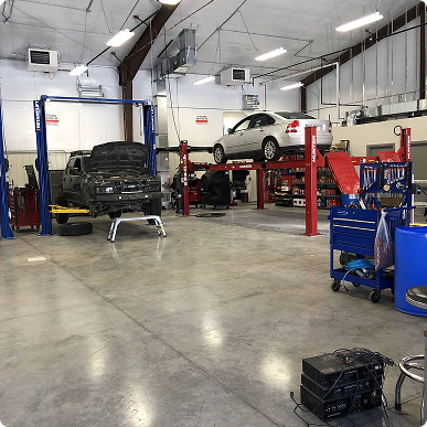 A car is sitting on a lift in a garage.  | Patterson Brothers Automotive
