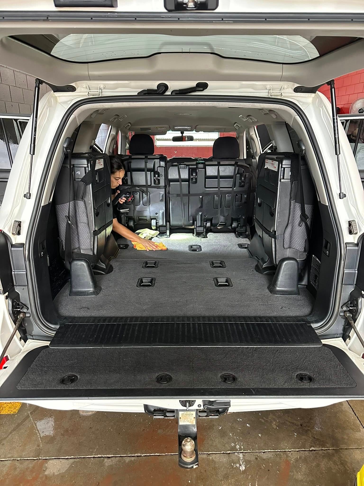 A Person Kneeling in the Back of an Open White Suv — Mobile Club Cars Cairns in Earlville, QLD