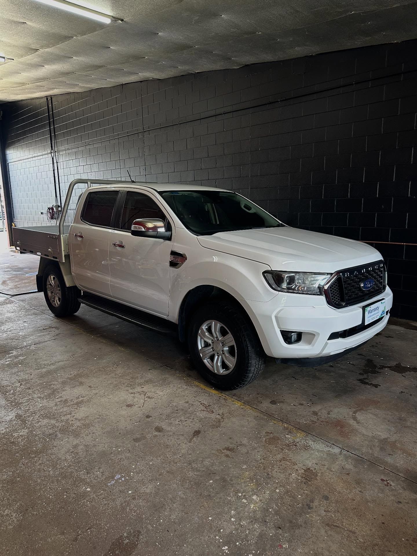 A White Ford Ranger Dual-cab Utility Vehicle With a Metal Tray — Mobile Club Cars Cairns in Mission Beach, QLD