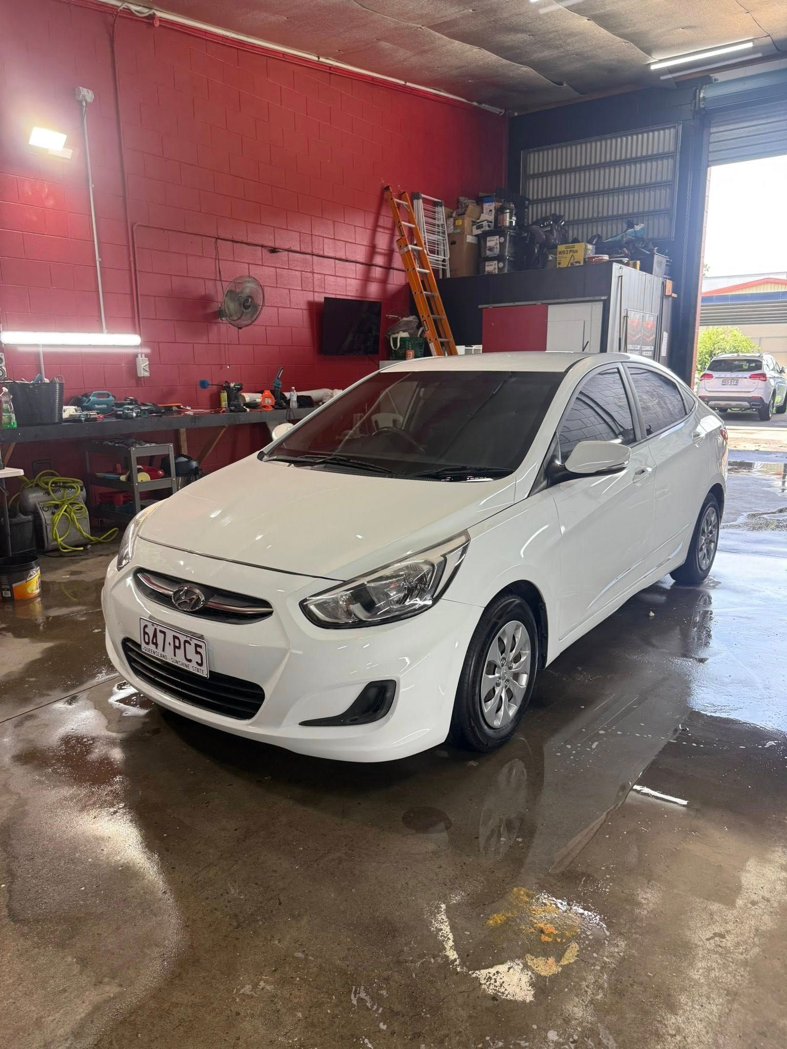 A White Hyundai Accent Parked Inside a Workshop — Mobile Club Cars Cairns in Mission Beach, QLD