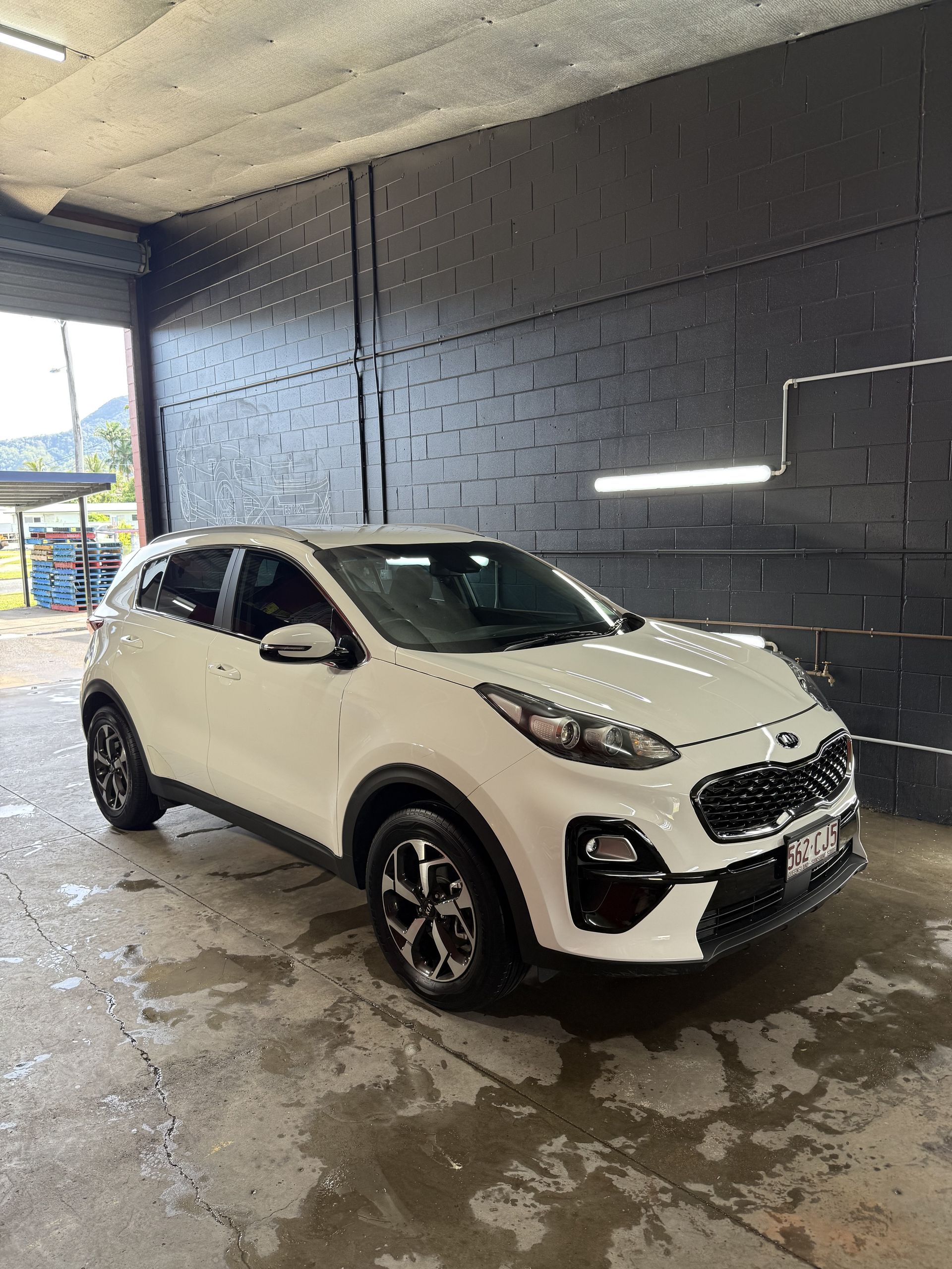 White Kia Sportage Suv Parked Inside a Garage — Mobile Club Car Cleaning in Earlville, QLD
