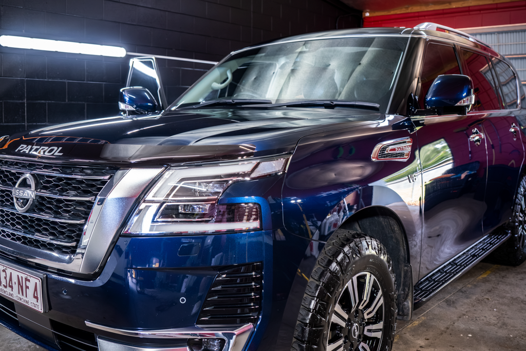 A Deep Blue Nissan Patrol Suv Parked in a Garage — Mobile Club Cars Cairns in Babinda, QLD