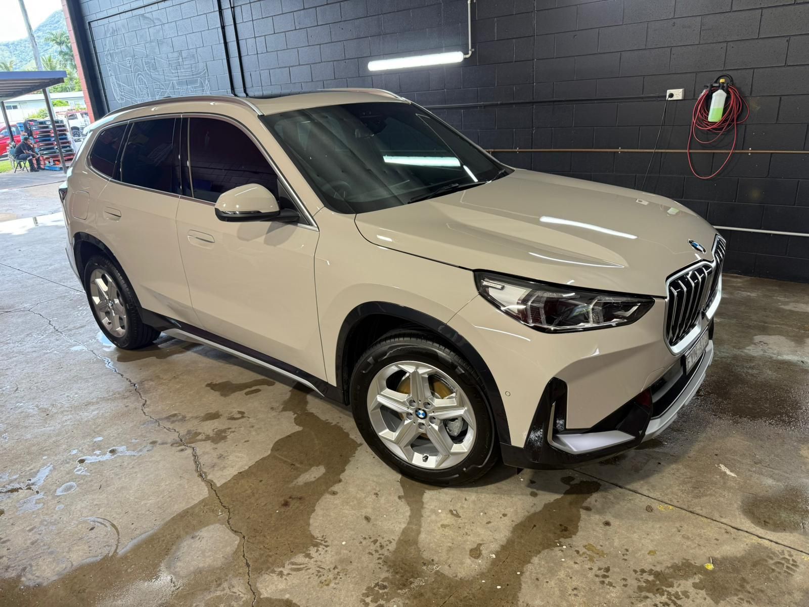 Beige BMW SUV parked in a garage, shiny — Mobile Club Cars Cairns in Earlville, QLD