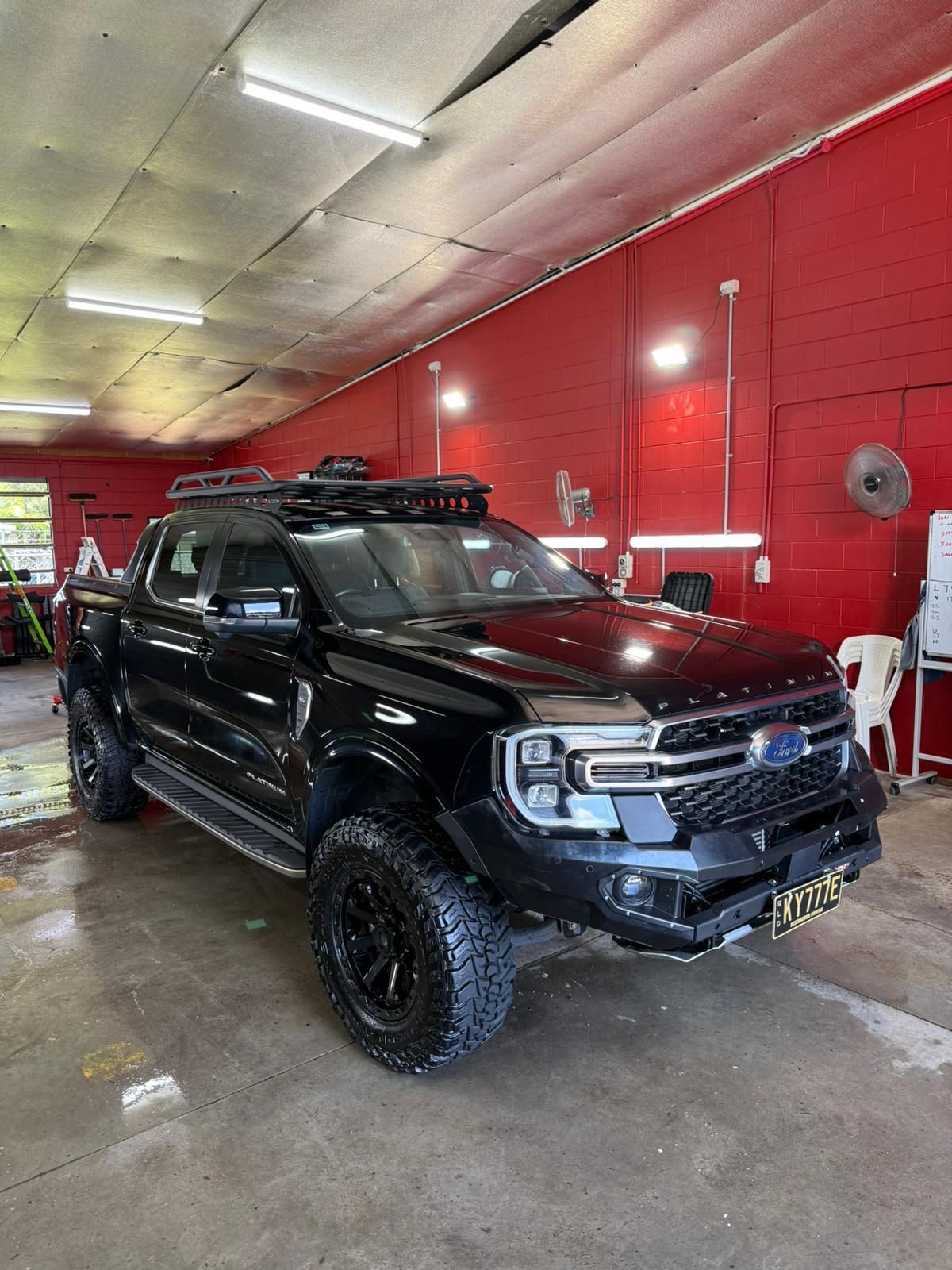 Black Ford Ranger pickup truck with off-road modifications — Mobile Club Cars Cairns in Earlville, QLD