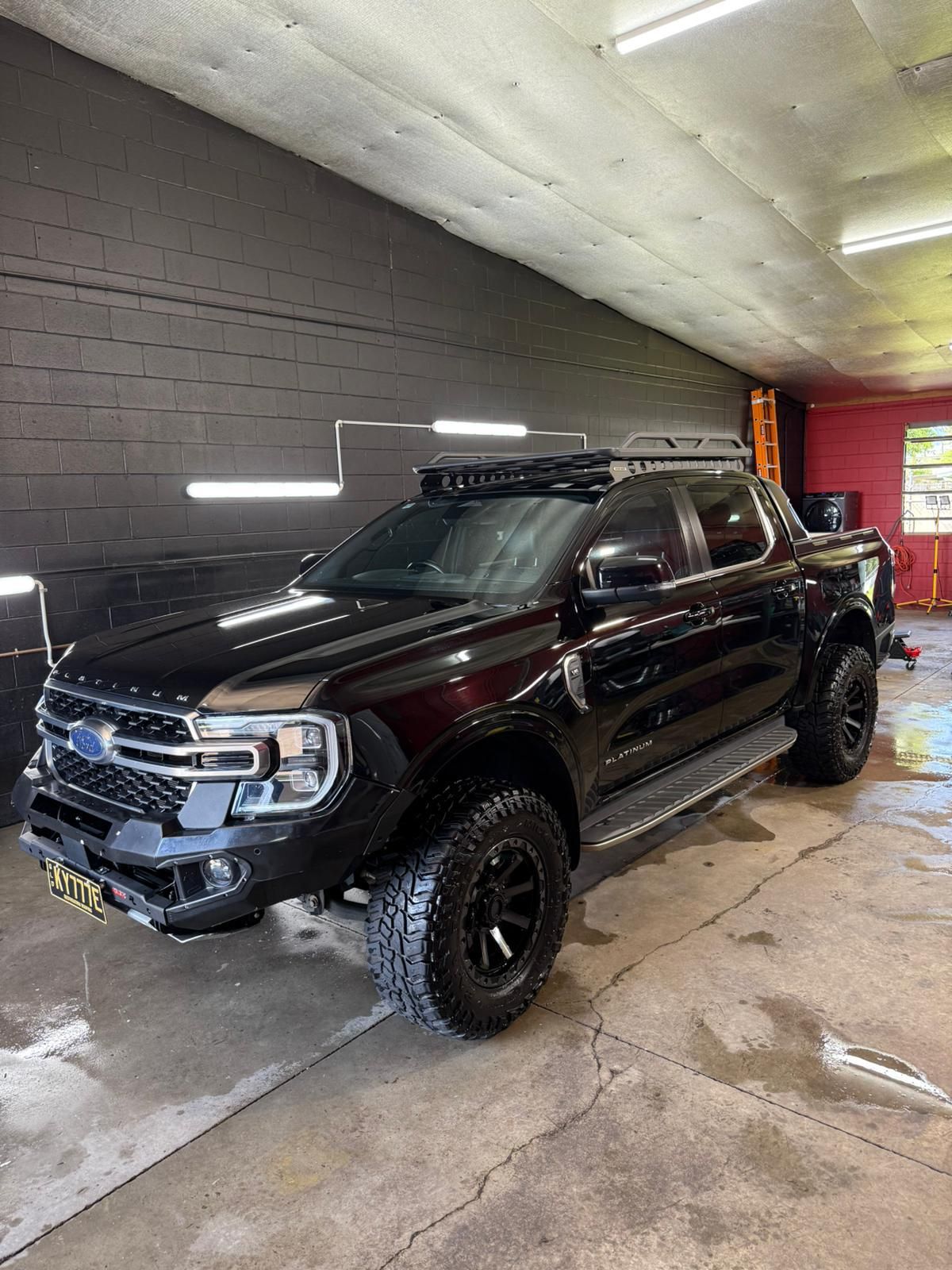 Black modified pickup truck with roof rack parked in a shop — Mobile Club Cars Cairns in Earlville, QLD