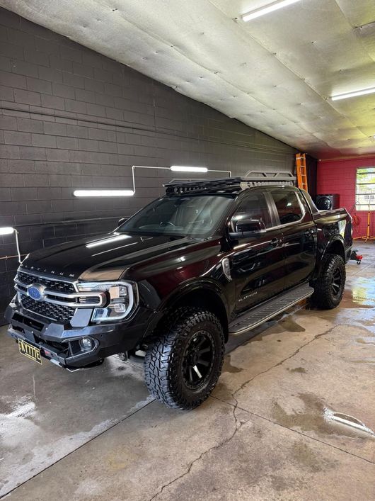Black pickup truck with roof rack, modified front bumper, and off-road tires — Mobile Club Cars Cairns in Earlville, QLD