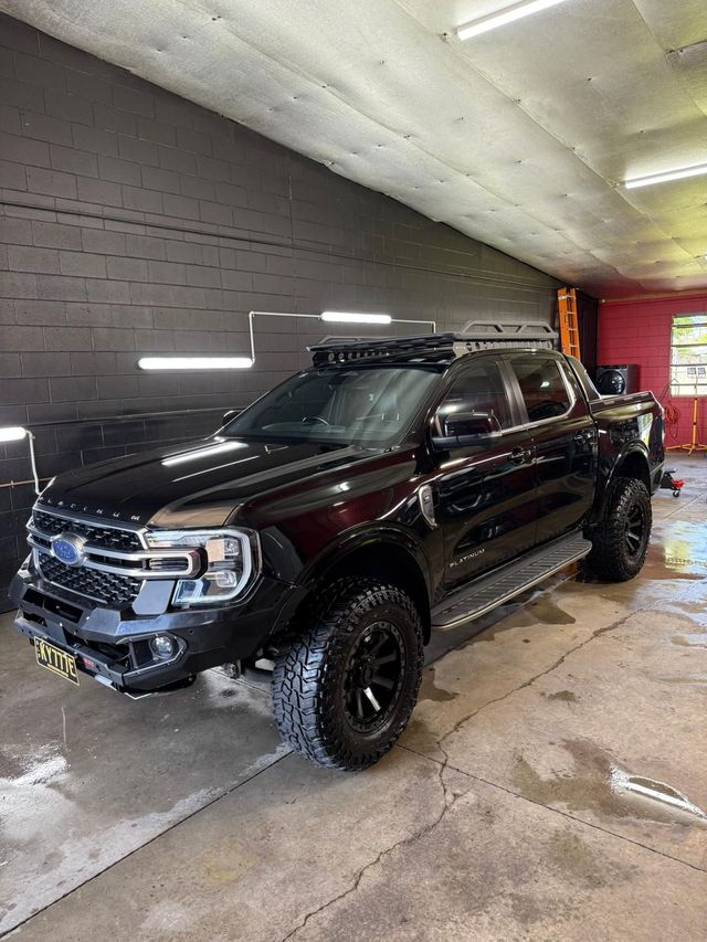Black pickup truck with roof rack, modified front bumper, and off-road tires — Mobile Club Cars Cairns in Earlville, QLD