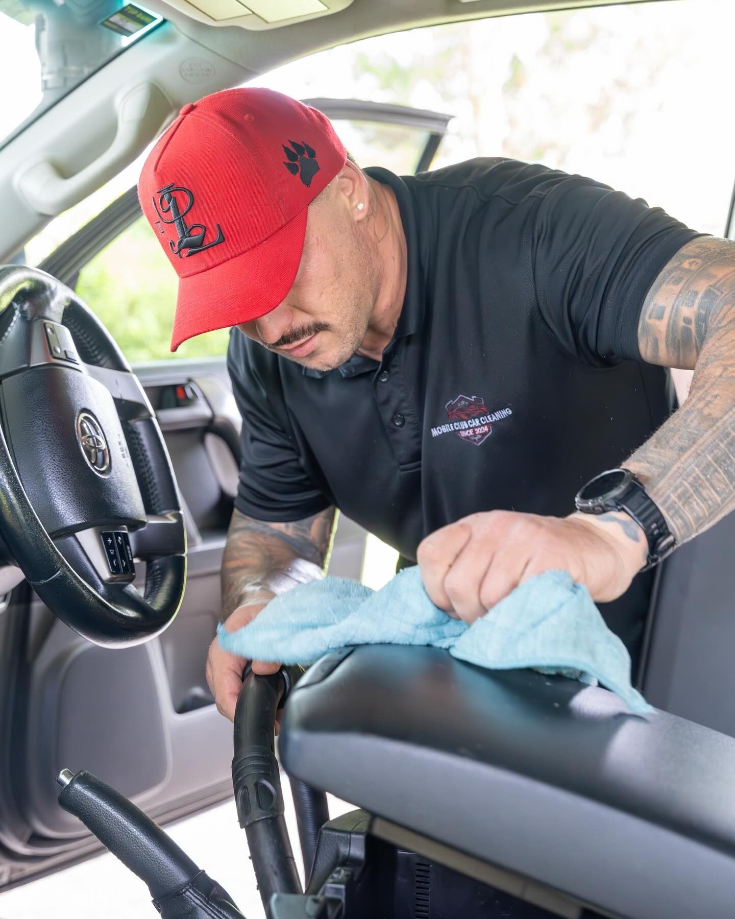 Man Cleaning Interior of a Car With a Blue Cloth — Mobile Club Car Cleaning in Earlville, QLD