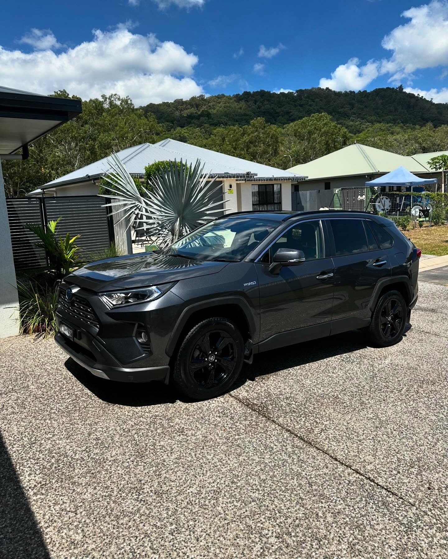 Dark Gray Toyota Rav4 Parked on a Paved Driveway — Mobile Club Car Cleaning in Earlville, QLD