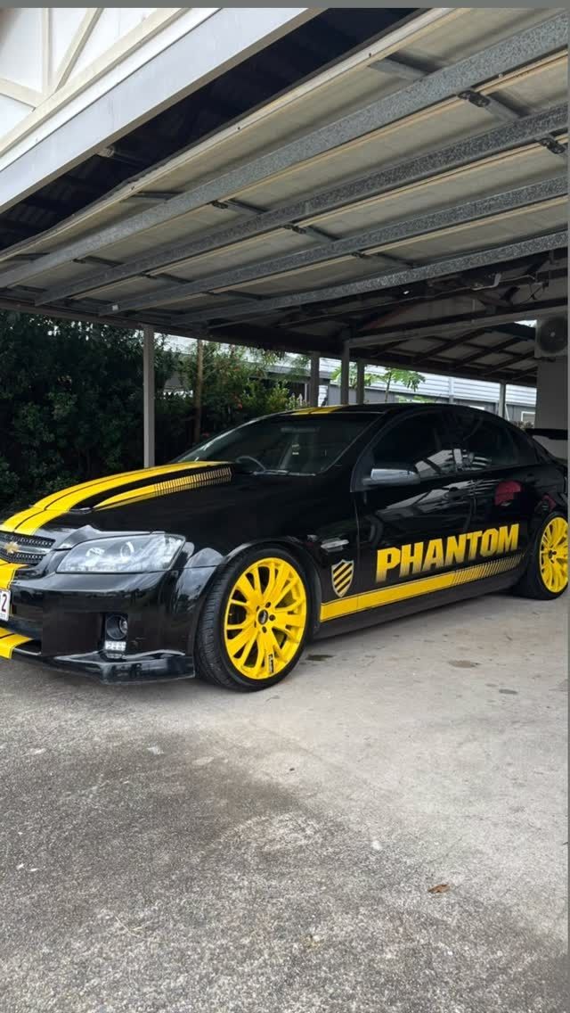 Black and yellow custom car parked under a carport – Mobile Club Car Cleaning in Earlville, QLD