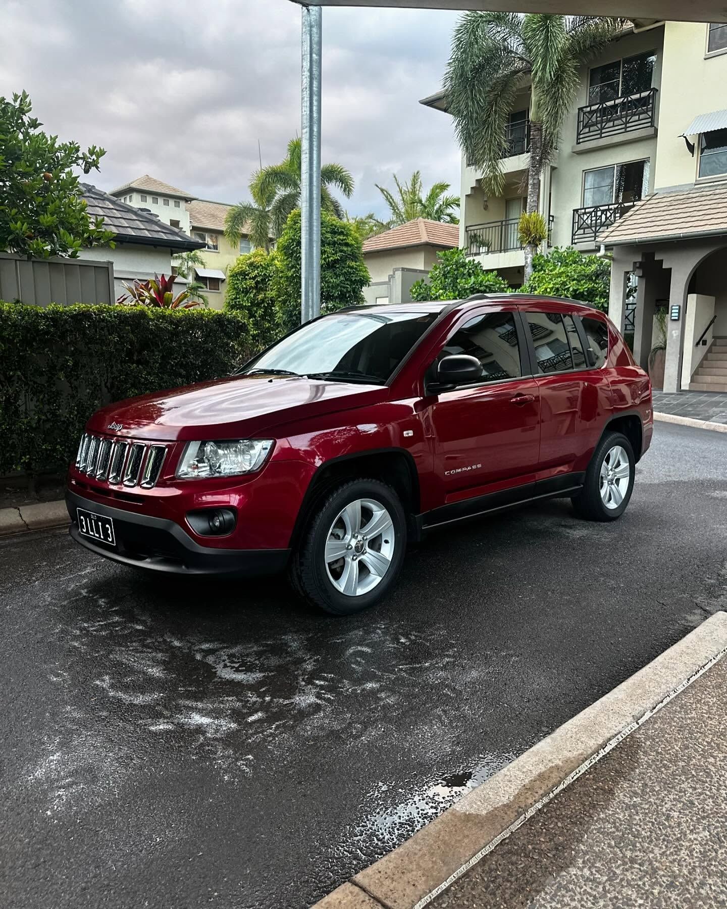 Red Jeep Compass Parked on a Wet Street — Mobile Club Car Cleaning in Earlville, QLD