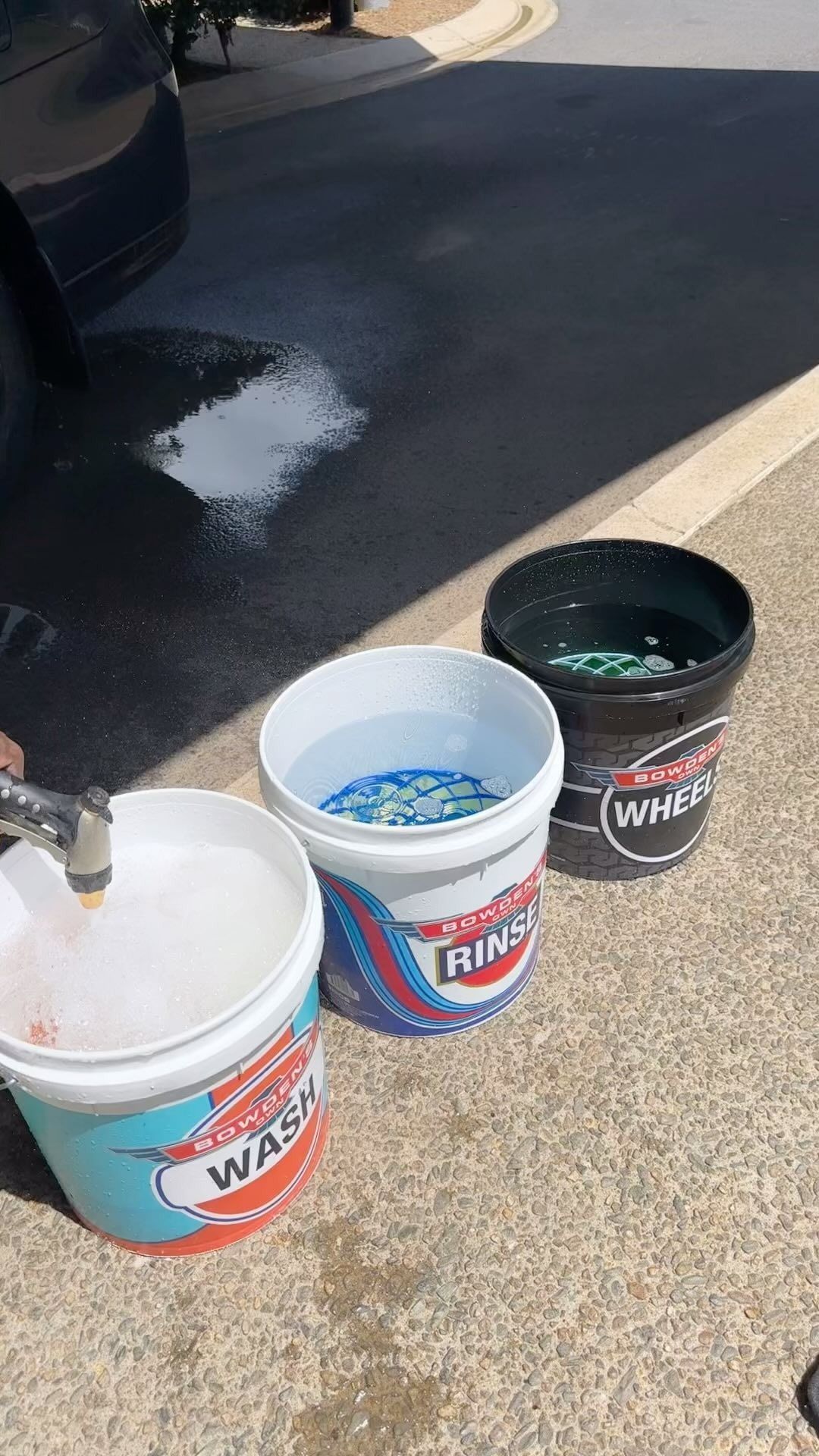Three buckets of car wash supplies on a driveway – Mobile Club Car Cleaning in Earlville, QLD